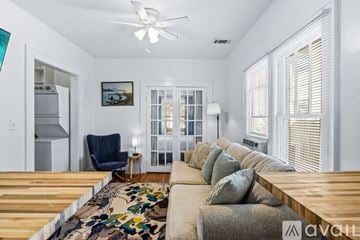 St. Petersburg apartment for rent - A living room with a couch, a chair, a rug, and a painting on the wall.