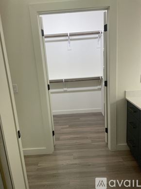 Denver apartment for rent - A white door with a black handle is open to a room with a grey floor.