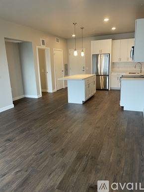 Denver apartment for rent - A kitchen with a refrigerator, sink, and cabinets.