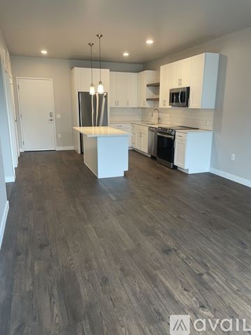 Denver apartment for rent - A kitchen with white cabinets and a wooden floor.