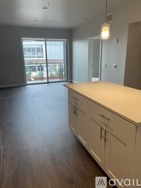 Denver apartment for rent - A kitchen with white cabinets and a wooden countertop.