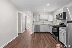 Atlanta house for rent - A kitchen with white cabinets and stainless steel appliances.