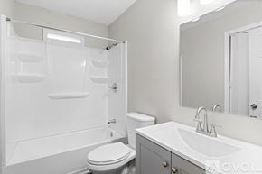 Atlanta house for rent - A white bathroom with a toilet, sink, and shower.