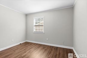 Atlanta house for rent - A room with a window and wooden flooring.