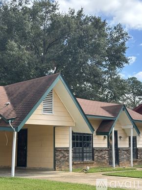 Jackson house for rent - A house with a brown roof and a green trim.