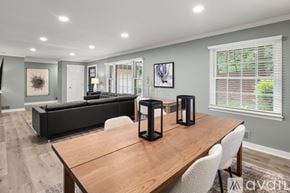 Asheville house for rent - A modern dining room with a wooden table and chairs.