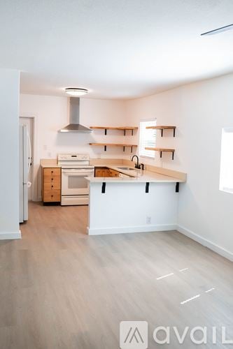 Sanford house for rent - A kitchen with a white counter and wooden floors.