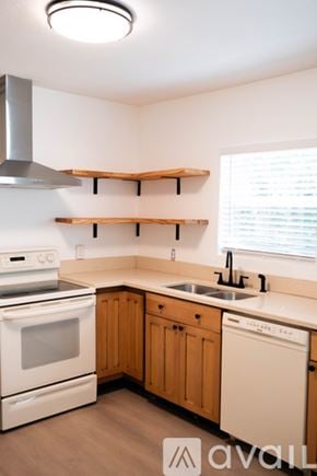 Sanford house for rent - A kitchen with wooden cabinets and a white oven.