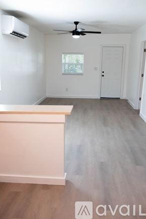 Sanford house for rent - A room with a ceiling fan and a window with blinds.