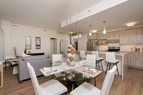 Winnipeg apartment for rent - A modern dining room with a glass table and white chairs.