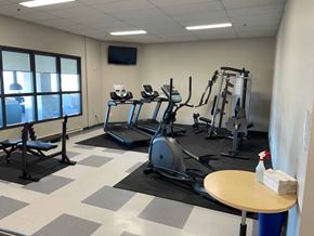 Winnipeg apartment for rent - A gym with treadmills, elliptical machines, and other exercise equipment.