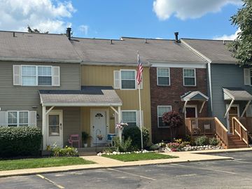 Comstock Park apartment for rent - A row of houses with a flag on the third one.