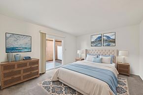 Fullerton apartment for rent - A bedroom with a large bed and a wooden dresser.