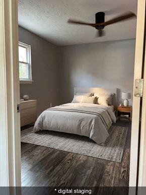 Lexington apartment for rent - A bedroom with a bed, nightstand, and a ceiling fan.