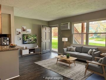 Lexington apartment for rent - A living room with a grey couch and a coffee table.