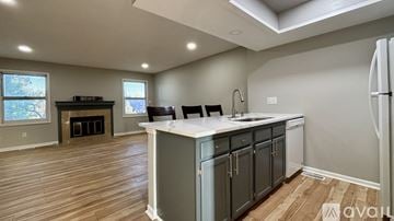 Indianapolis house for rent - A kitchen with wooden floors and a white countertop.