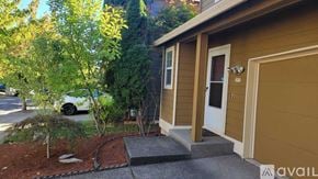 Beaverton house for rent - A small house with a brown garage door is shown.
