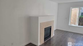 Beaverton house for rent - A room with a fireplace and a window.