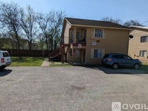 San Marcos apartment for rent - A two-story house with a garage and a car parked in front.