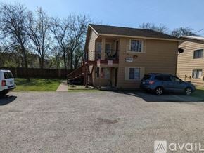 San Marcos apartment for rent - A two-story house with a garage and a car parked in front.