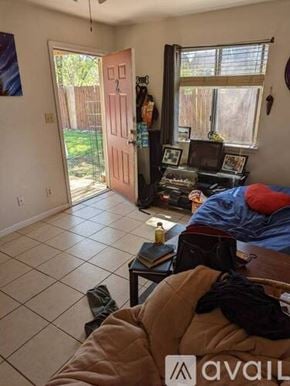 San Marcos apartment for rent - A room with a bed, a table, and a window.
