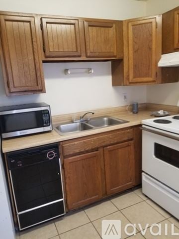 San Marcos apartment for rent - A kitchen with wooden cabinets and a white oven.