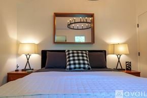 Woodstock house for rent - A bedroom with a bed, two lamps, and a mirror on the wall.