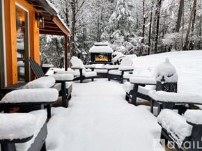 Woodstock house for rent - A snow-covered picnic area with a fire pit in the middle.