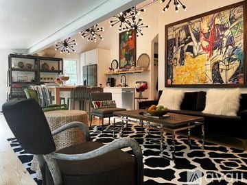 Woodstock house for rent - A modern living room with a large abstract painting on the wall.