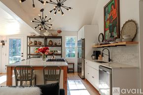Woodstock house for rent - A kitchen with a table and chairs in the middle of the room.