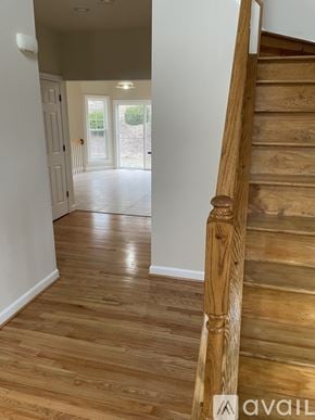 Owings Mills house for rent - A wooden staircase leads to a bright open space.
