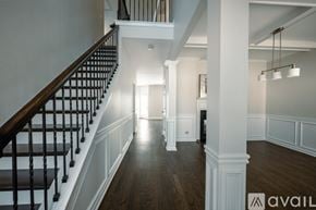 Atlanta house for rent - A spacious hallway with a staircase on the left and a doorway on the right.