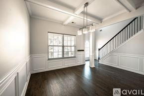 Atlanta house for rent - A spacious room with wooden floors and a staircase with black railings.
