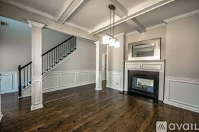 Atlanta house for rent - A spacious living room with a fireplace and a staircase.