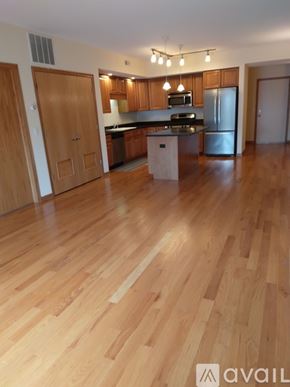 Chicago apartment for rent - A kitchen with wooden floors and cabinets.