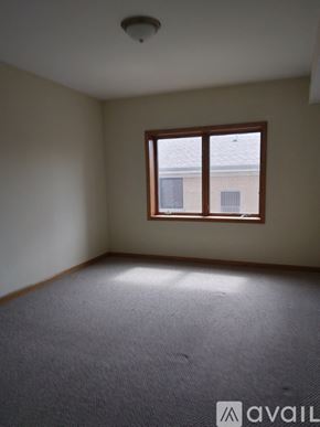 Chicago apartment for rent - A room with a carpeted floor and a window.