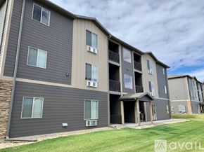 Box Elder apartment for rent - A large apartment complex with multiple balconies and units.