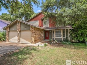 Austin townhouse for rent - A house with a red door and a garage door is for sale.