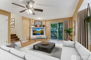 Austin townhouse for rent - A living room with a white couch and a flat screen TV mounted on the wall.
