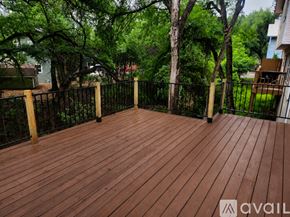 Austin townhouse for rent - A bedroom with a bed, dresser, and window with curtains.