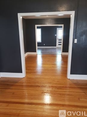 Albany house for rent - A room with wooden floors and a white doorway leading to another room.