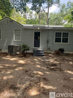 Albany house for rent - A house with a grey siding and a blue door is for sale.