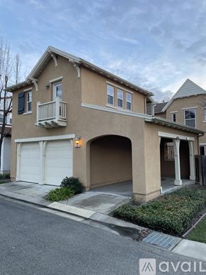 San Ramon house for rent - A two-story house with a beige exterior and a white garage door.