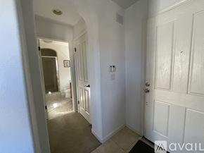 San Ramon house for rent - A hallway with a door on the right and a bathroom visible in the background.