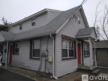 Mahwah house for rent - A house with a red door and a grey siding is for sale.
