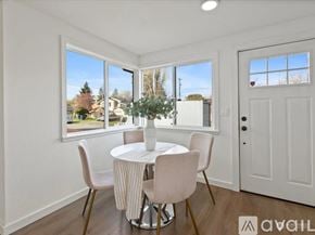 Seattle apartment for rent - A living room with a large couch, a coffee table, and a flat-screen TV mounted on the wall.
