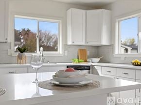Seattle apartment for rent - A dining room with a table and chairs and a view of the outside.