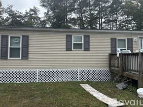 Leonardtown house for rent - A mobile home with a white picket fence in front.
