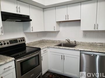 Telford apartment for rent - A kitchen with white cabinets and a granite countertop.