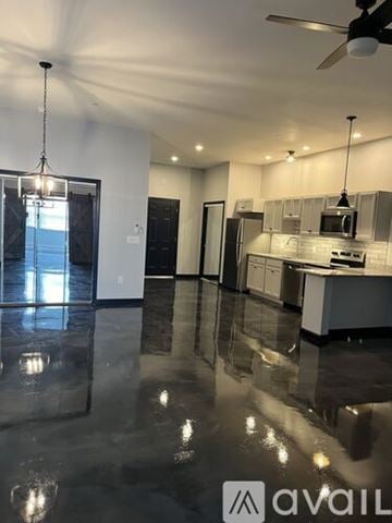 Littleton apartment for rent - A spacious kitchen and living room with a marble floor and modern appliances.